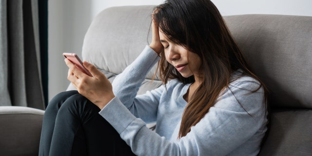 Depressed woman with phone