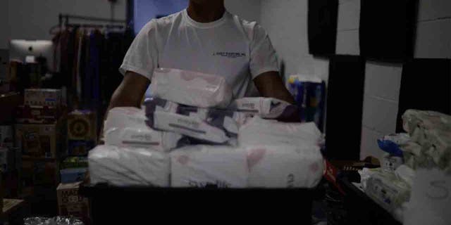 man holding box of diapers