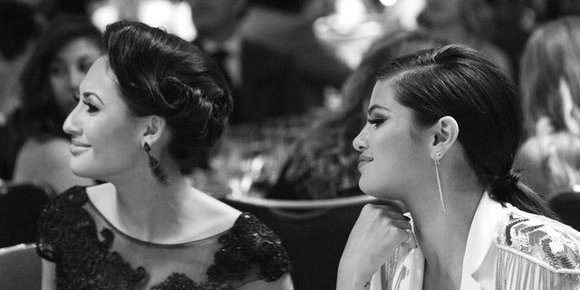 Francia Raisa and Selena Gomez sitting together