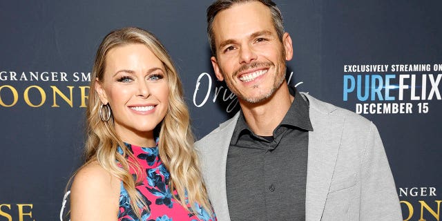 granger smith with wife amber on red carpet