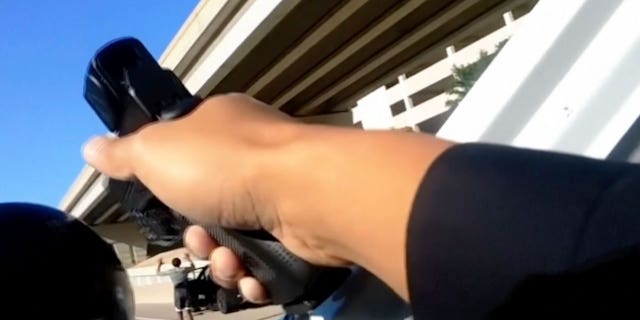 body camera image of police pointing a gun at a woman