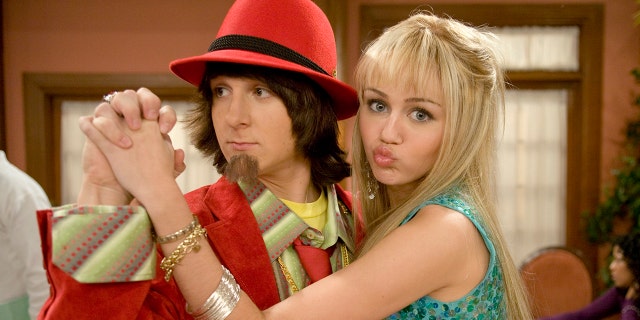Mitchel Musso and Miley Cyrus hold hands on Hannah Montana