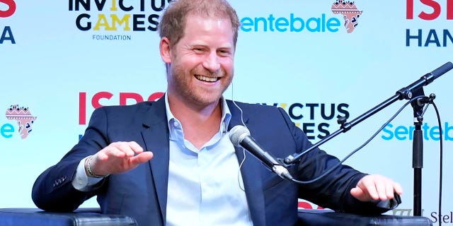 prince harry sitting on panel at sports summit in japan