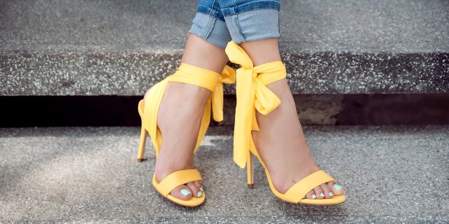 woman wears yellow sandals