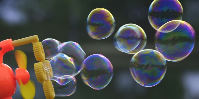 A bubble gun in-use outside.