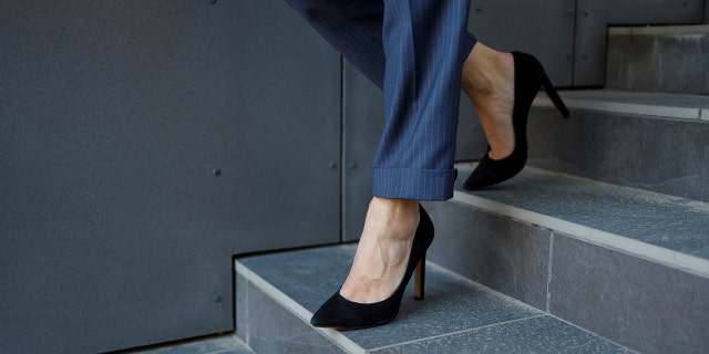 businesswoman walks downstairs