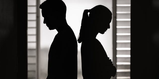 Couple turns their backs to each other.