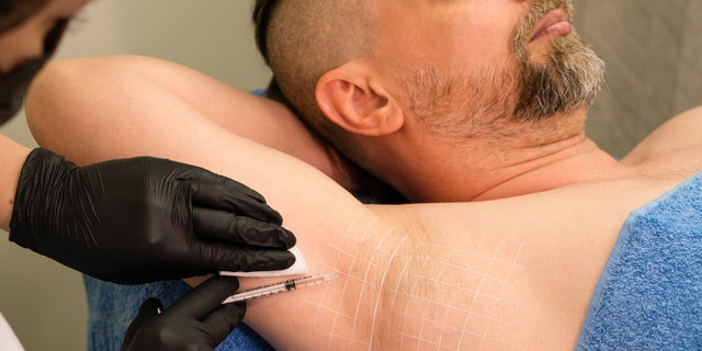 Man gets injection for his armpit.