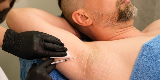 Man gets injection for his armpit.