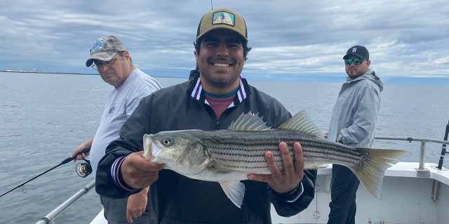 veteran holds a fish