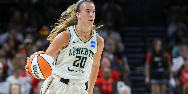 Sabrina Ionescu dribbles