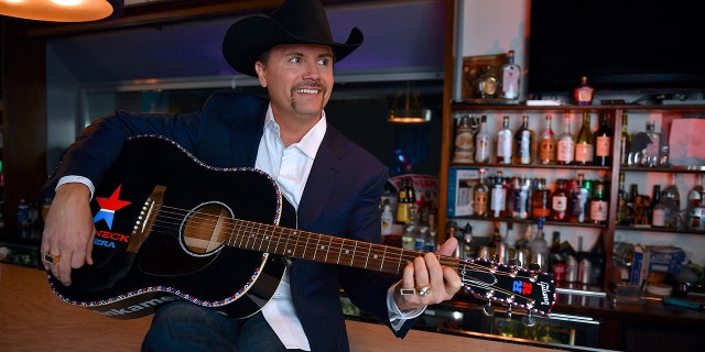 John Rich strums guitar at Redneck Riviera bar