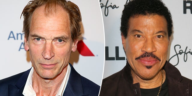 Julian Sands in a white shirt and navy jacket on the carpet split Lionel Richie in a brown jacket on the carpet