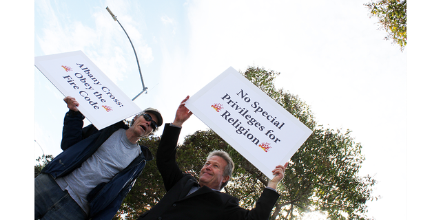 photo of atheists protesting cross