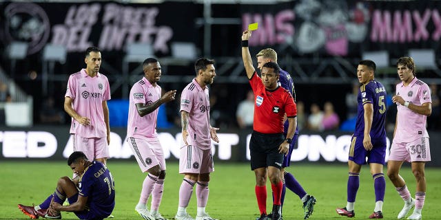 Lionel Messi gets a yellow card