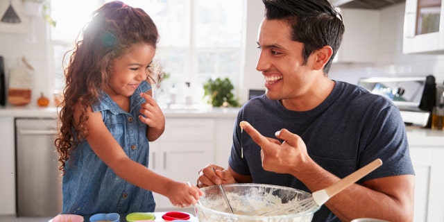 cracking egg trend father in the kitchen with child