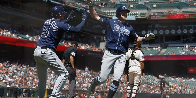 Luke Raley high fives teammate