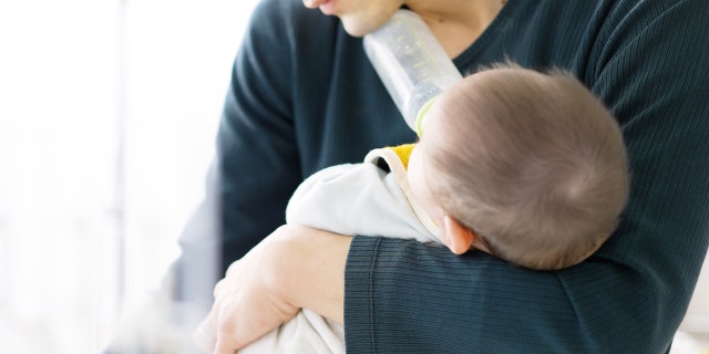 Man nursing baby