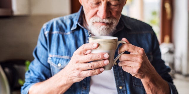 Man smelling coffee