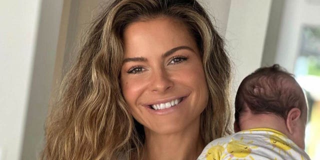 maria menounos smiling and holding her baby daughter