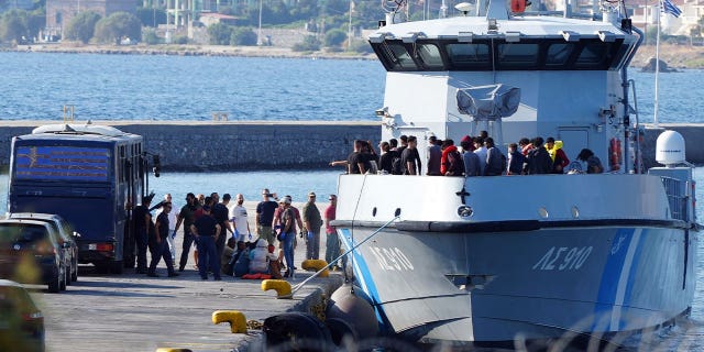 greek coast guard carrying migrants