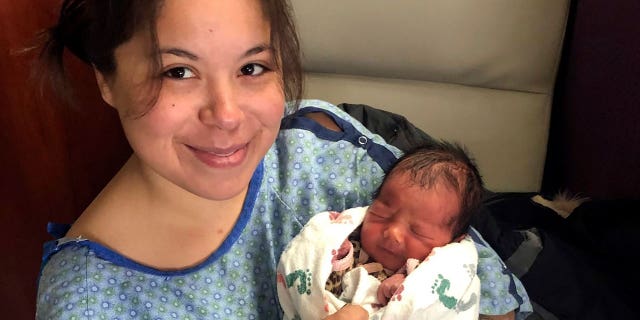 destinee thompson holds baby