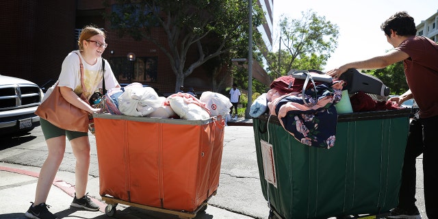 Students pushing carts on college move-in day
