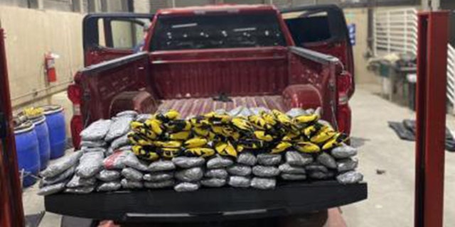 Red truck shown with packages of narcotics