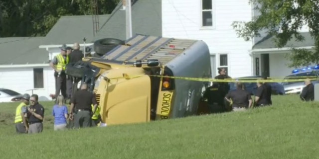 investigators outside overturned school bus