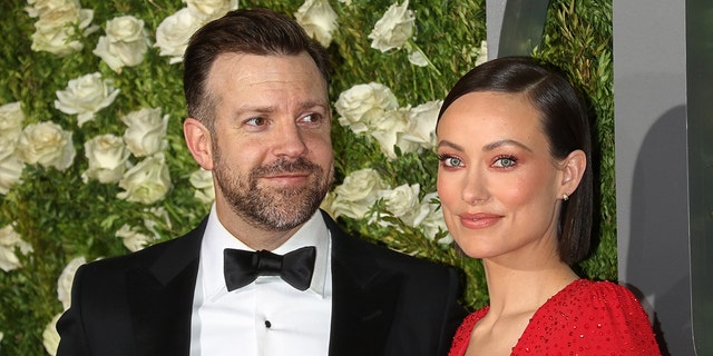 Olivia Wilde wears red dress at red carpet event with Jason Sudeikis