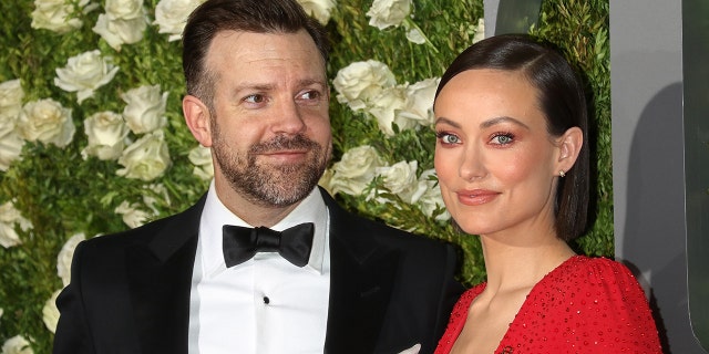 Olivia Wilde wears red dress at red carpet event with Jason Sudeikis