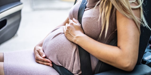 Pregnant woman in car