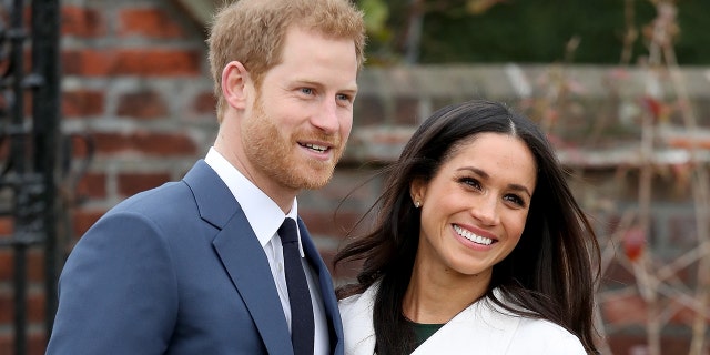 Prince Harry and Meghan Markle smile as senior royals