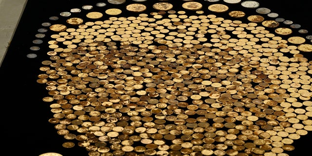 raw coins on black table