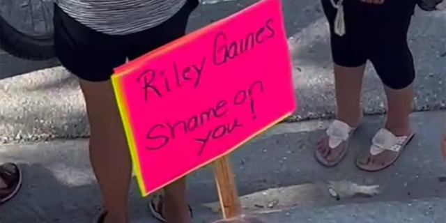 Riley Gaines protest sign