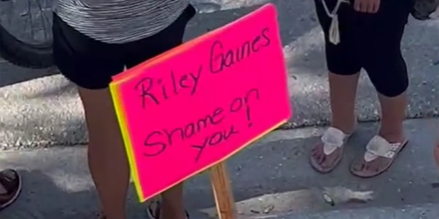 Riley Gaines protest sign