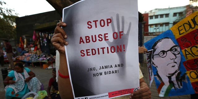 protestor holding placard against abuse of sedition