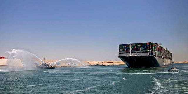 Tugboat next to tanker in Suez Canal
