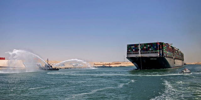 Tugboat next to tanker in Suez Canal