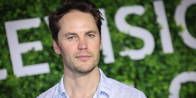 Taylor Kitsch in a light blue button down shirt in Monte-Carlo