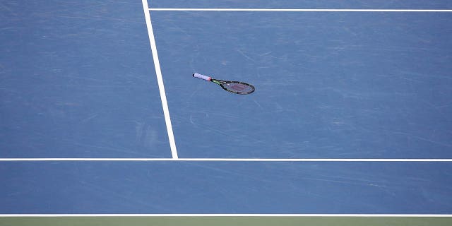 tennis racket on a hard court