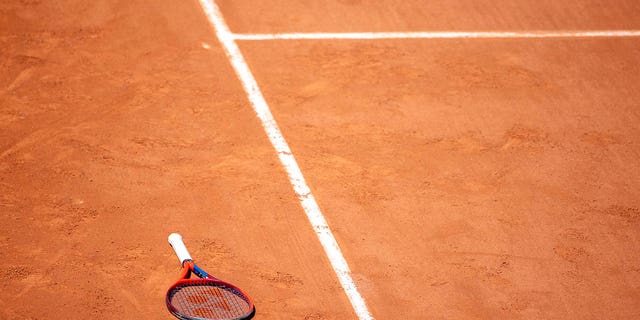 tennis racket on a clay court