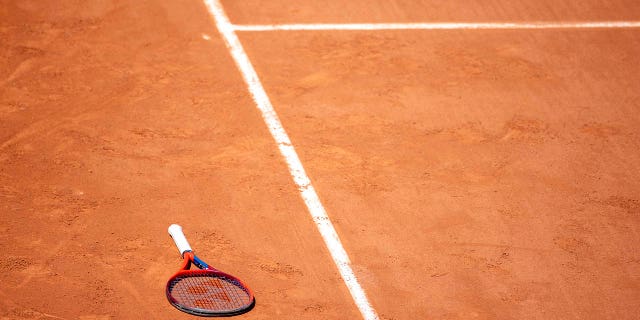 tennis racket on a clay court