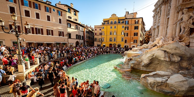 Tourists gathered around the Trevi Fountain