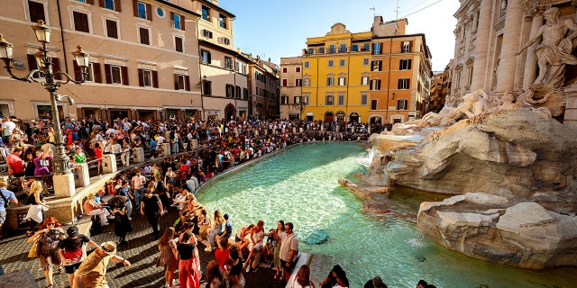 Tourists gathered around the Trevi Fountain