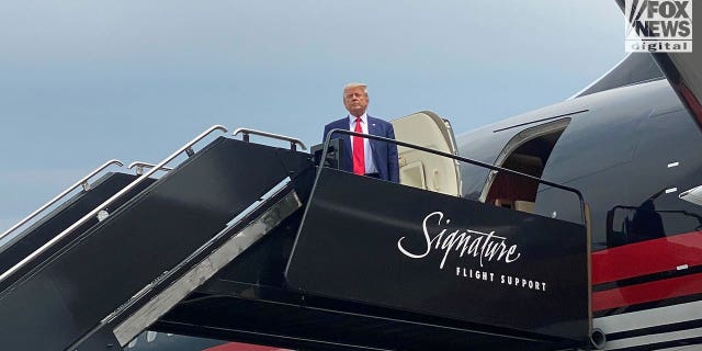 Donald Trump wears suit and red tie