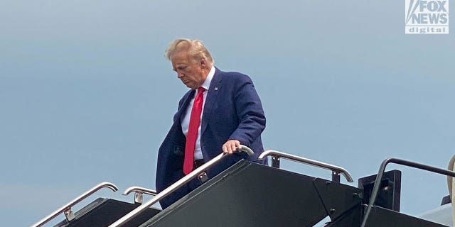Donald Trump wears suit and red tie