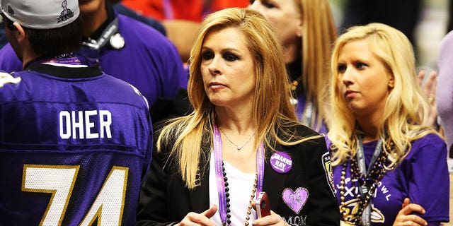 Leigh Anne Tuohy on field at the Super Bowl adorned with purple