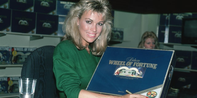 Vanna White signs Wheel of Fortune game