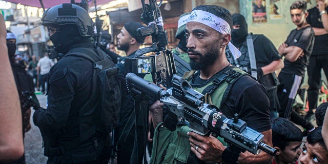 militant carrying weapon